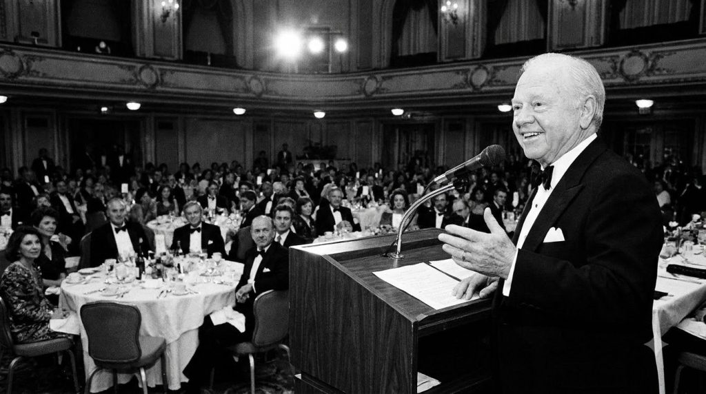 Mickey Rooney in an archival photo from his later career perhaps accepting an award or at a public event showing his dis