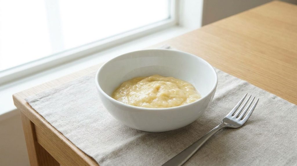 A bowl with a mashed ripe banana ready for the berries to be added