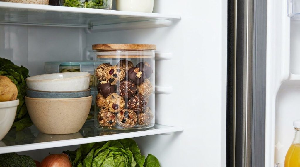 Healthy homemade chocolates stored in an airtight container in the refrigerator