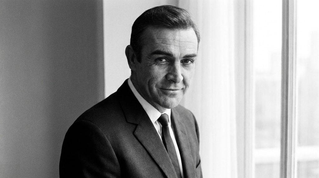 A portrait of Sean Connery looking dapper and charming possibly in his prime as James Bond