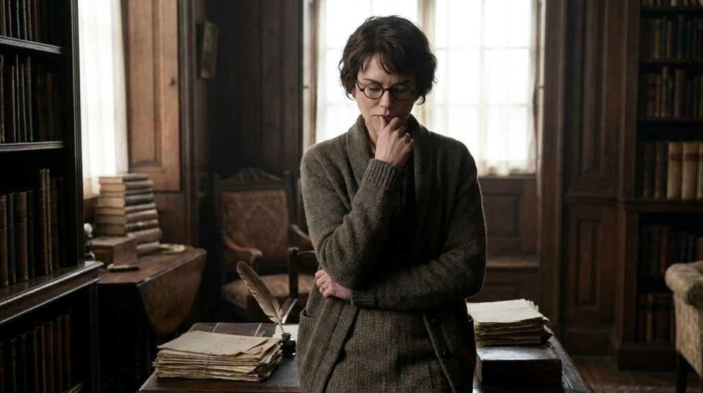 Nicole Kidman in a period costume with short dark hair and glasses looking intensely portraying Virginia Woolf in The Ho