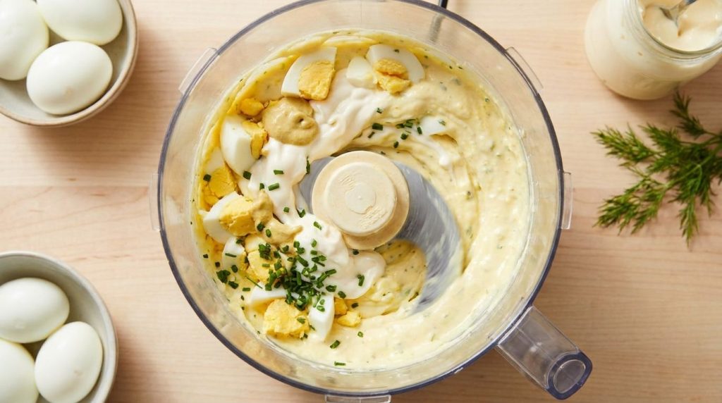 Ingredients blending in a food processor for boiled egg mayonnaise