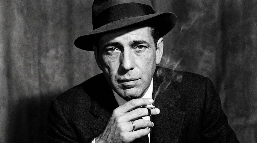 A black and white publicity photo of Humphrey Bogart looking cool and intense