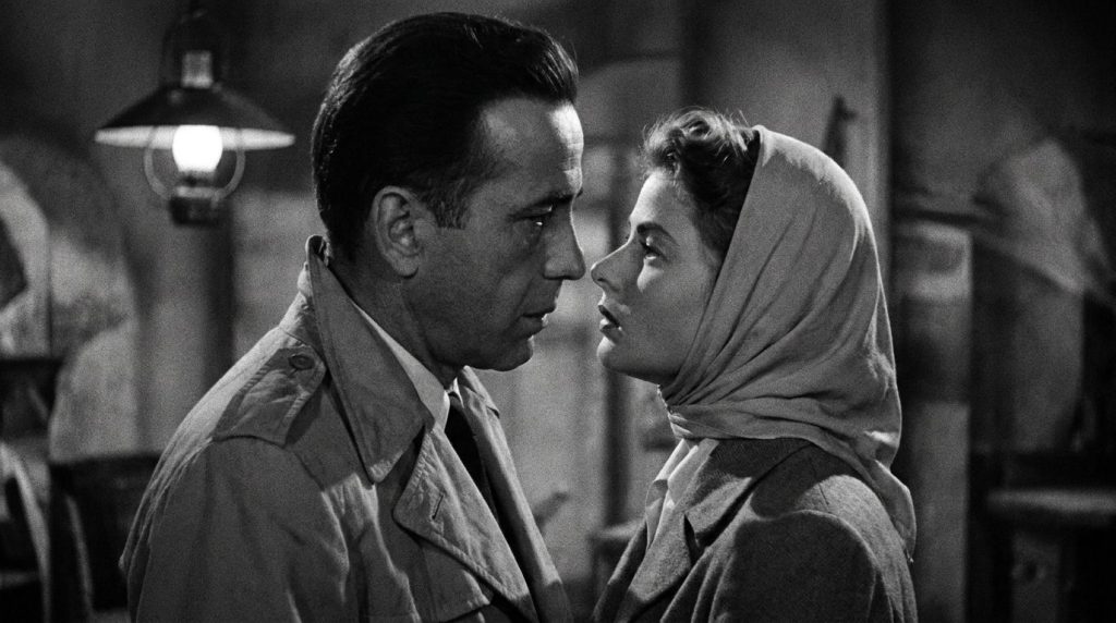 A black and white still of Humphrey Bogart and Ingrid Bergman in a romantic scene from Casablanca