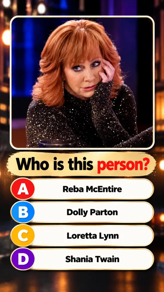 A younger Reba McEntire performing on stage with her signature red hair and a dazzling outfit spotlight shining on her