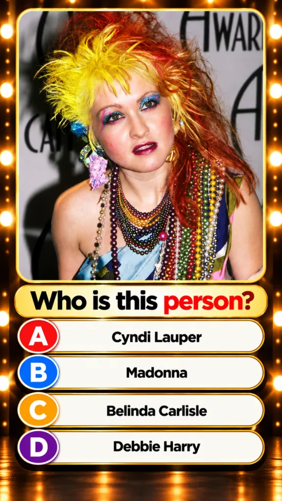 Vibrant portrait of Cyndi Lauper from the 1980s with her signature bright yellow orange and red spiky hair extravagant c