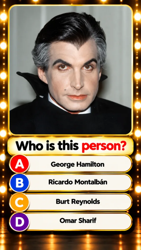 George Hamilton as a vampire in a movie still with pale skin dark hair with gray streaks and a black vampire cape The im