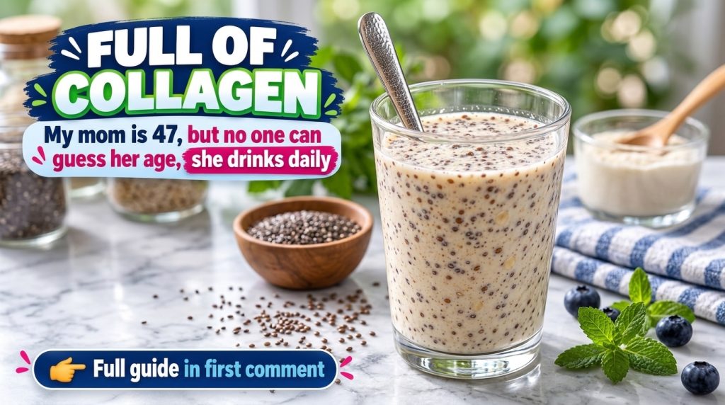 A glass of creamy liquid with suspended chia seeds and a spoon surrounded by fresh blueberries mint leaves and a small b