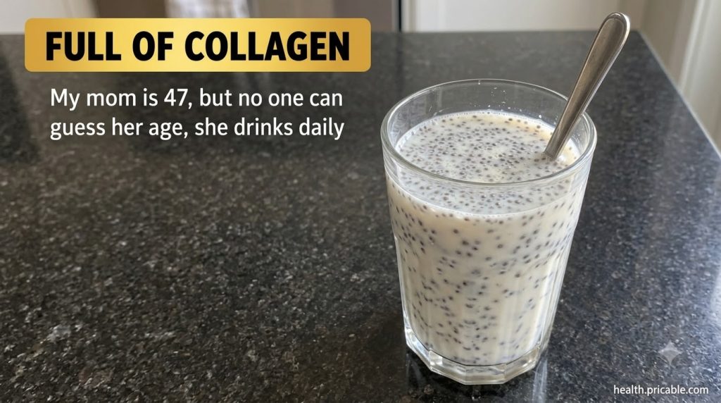A glass with a milky white drink and dark chia seeds with a spoon inside similar to the source image