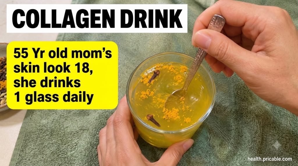 A close-up of a clear glass holding a yellowish-green beverage with turmeric powder and two cloves stirred with a metal 