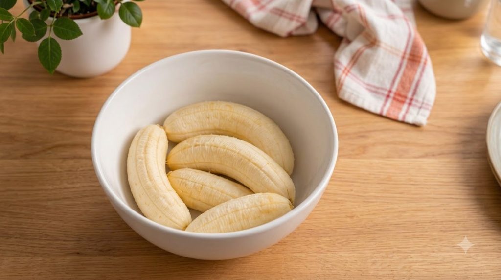 A close-up shot of several golden-brown banana coconut cookies arranged artfully on a cooling rack or rustic wooden boar