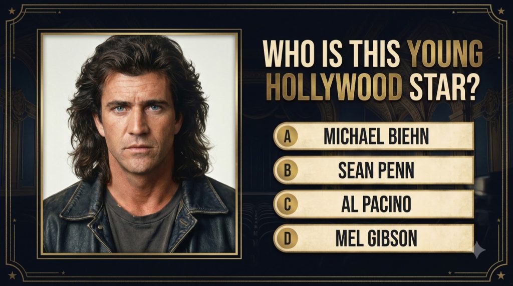 A portrait of a young Mel Gibson from the 1980s featuring his long wavy dark brown hair and intense blue eyes wearing a 