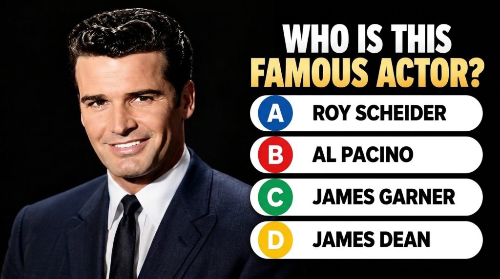 A handsome smiling man in a dark suit and tie against a black background This is the quiz image