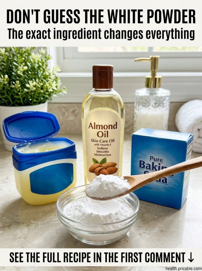 A small glass jar of homemade skin balm with a creamy white texture next to a tube of Vaseline and a bottle of almond oi