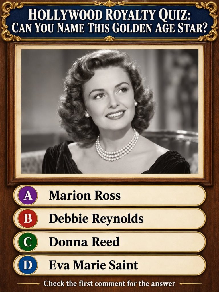 A black and white portrait of a glamorous woman from the Golden Age of Hollywood featuring a radiant smile and wearing c