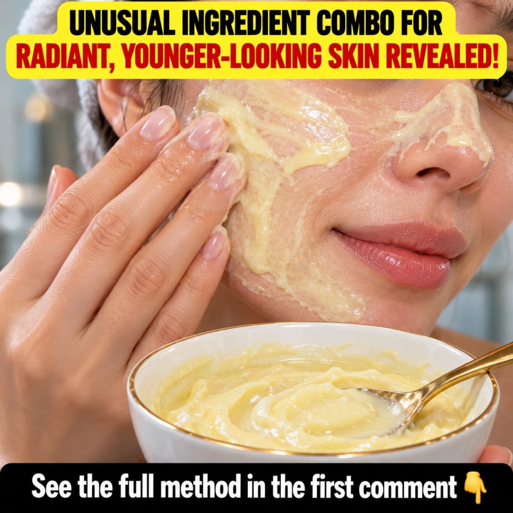 A close-up shot of a small wooden bowl containing a yellow turmeric and honey mask mixture with a spoon beside it and a